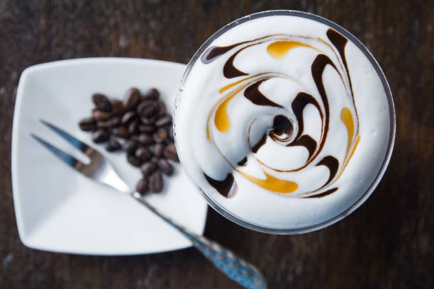 istock Coffee cup and saucer on a wooden table, shallow DOF 692230440