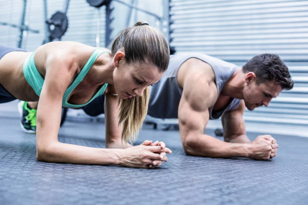 istock Muscular couple doing planking exercises 692237524