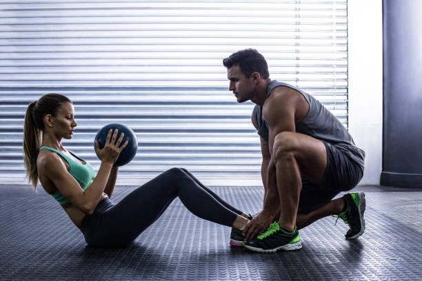 istock Muscular couple doing abdominal ball exercise 692240210