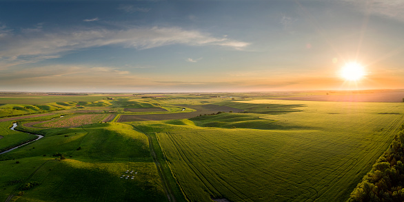 Early May aerial South Dakota panoramic sunrise over farm land.