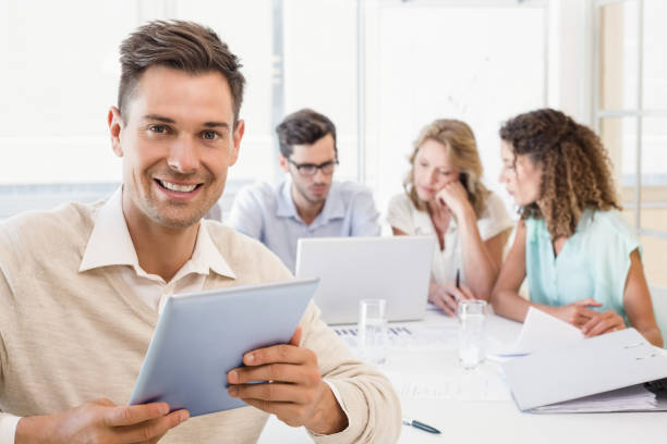 istock Casual businessman smiling at camera during meeting 692242916