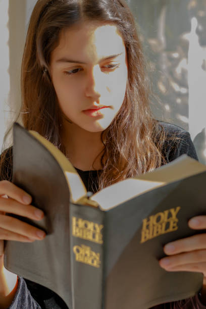 istock Girl reads the Bible 692243866