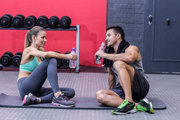 istock Sitting muscular couple talking together 692244028