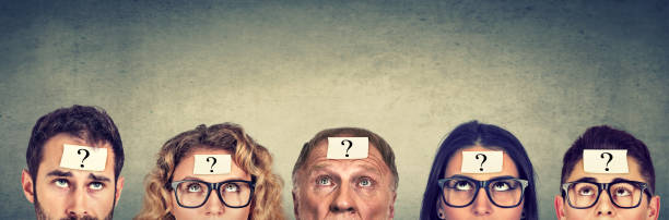 istock Multiethnic group of thinking people with question mark looking up 692253628