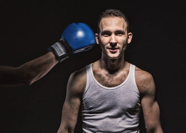 istock Boxing glove near the man's face 692256446