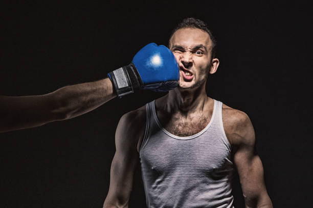 Boxing kick in the face Boxing kick in the face on black background knockout stock pictures, royalty-free photos & images