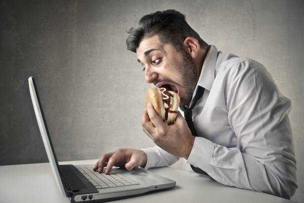 hungry office worker - eating sandwich emotional stress food imagens e fotografias de stock