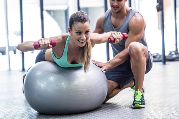 istock Muscular woman lifting a dumbbell 692256540