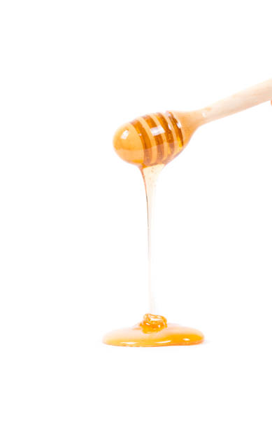 istock The flowing honey is accumulating in the ground 692256552
