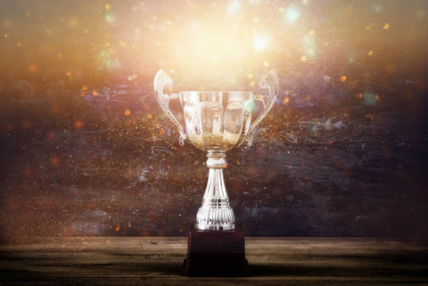 istock low key image of trophy over wooden table and dark background 692257018
