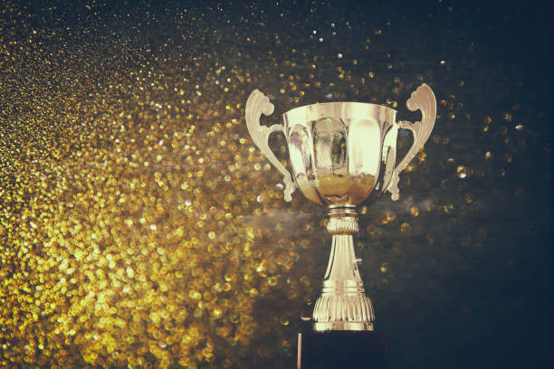istock low key image of trophy over wooden table and dark background 692257022