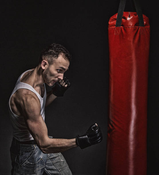 istock Boxer man and red punching pear 692257128
