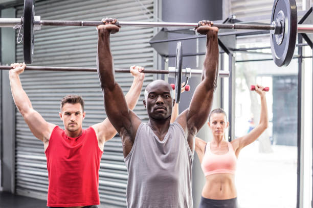 Three muscular athletes lifting barbells
