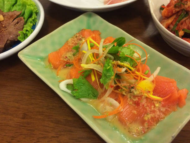 istock Spicy Salmon Salad with vegetable in green bow 692260188