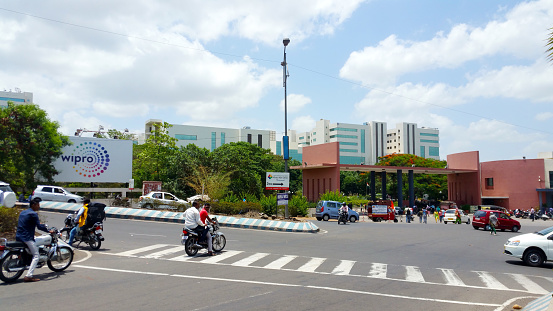 Pune, India: People and vehicles at the entrance gate of of Wipro IT company office in Hinjewadi, Pune, India. Wipro Limited is a global information technology company involved in consulting business with around 200000 employee workforce and having offices in around 180 cities worldwide.