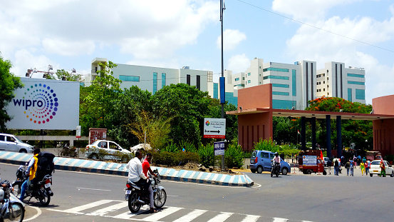 Pune, India: People and vehicles at the entrance gate of of Wipro IT company office in Hinjewadi, Pune, India. Wipro Limited is a global information technology company involved in consulting business with around 200000 employee workforce and having offices in around 180 cities worldwide.