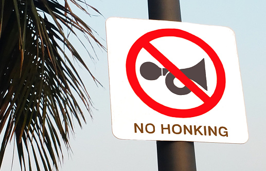 No Honking - No Horn sign board on a road put by traffic police in India