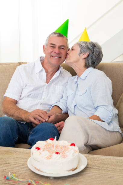 istock Senior couple sitting on couch celebrating a birthday 692264010