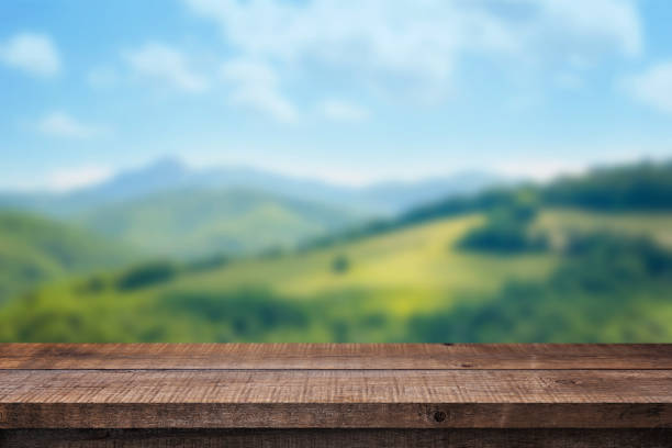 istock Empty wooden desk with free space for product presentation. Nature in background. 692270064