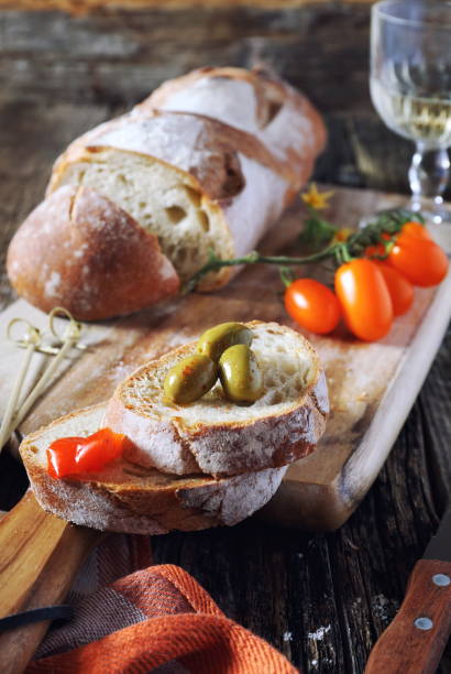 istock Appetizer: bread, cherry tomatoes, olives and white wine 692273782