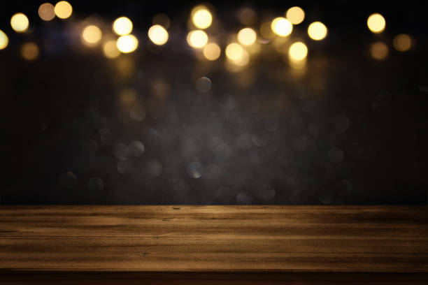 istock Empty table in front of black and gold glitter lights background 692274102
