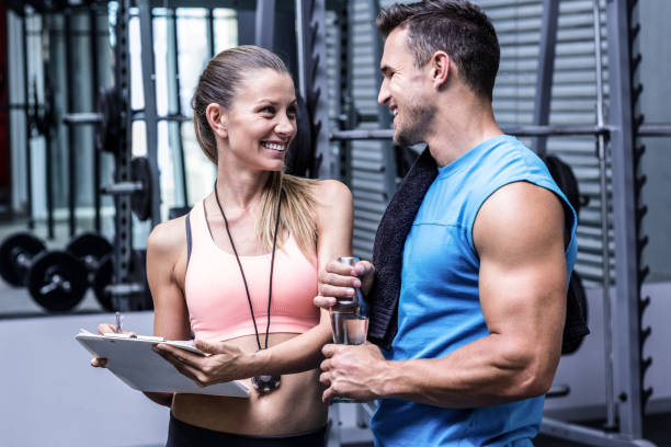 istock Female coach discussing with a muscular man 692279176