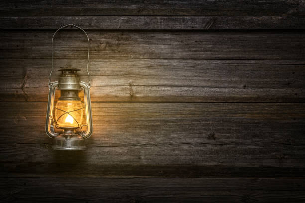 the old kerosene lamp on wooden background - oil lantern imagens e fotografias de stock