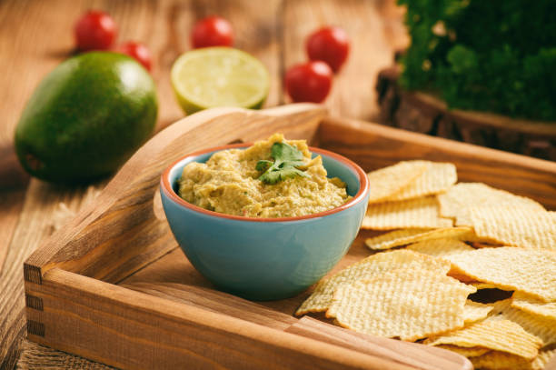 istock Guacamole - mexican avocado dip with tomato and lime. 692285926