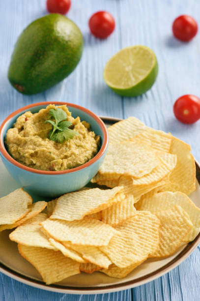 istock Guacamole - mexican avocado dip with tomato and lime. 692285934