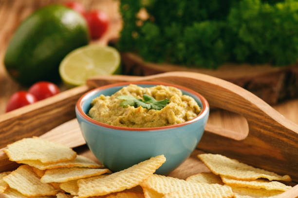 istock Guacamole - mexican avocado dip with tomato and lime. 692285976