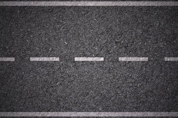 istock white lines on street background 692286684