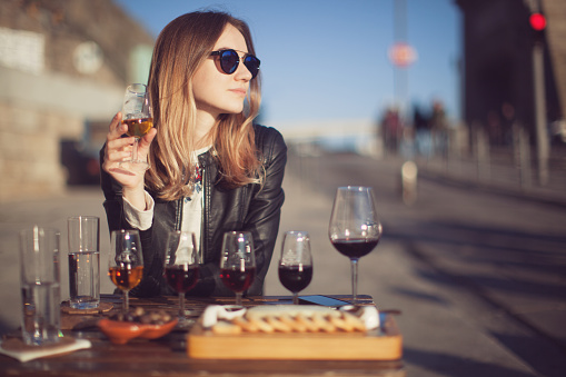 Woman with wine testing glasses