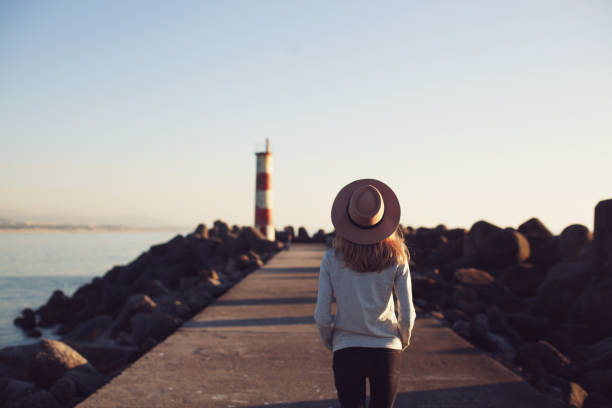 istock Young woman at lighthouse 692288998