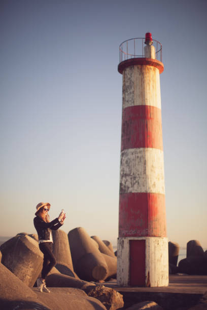 istock Young woman at lighthouse 692289548