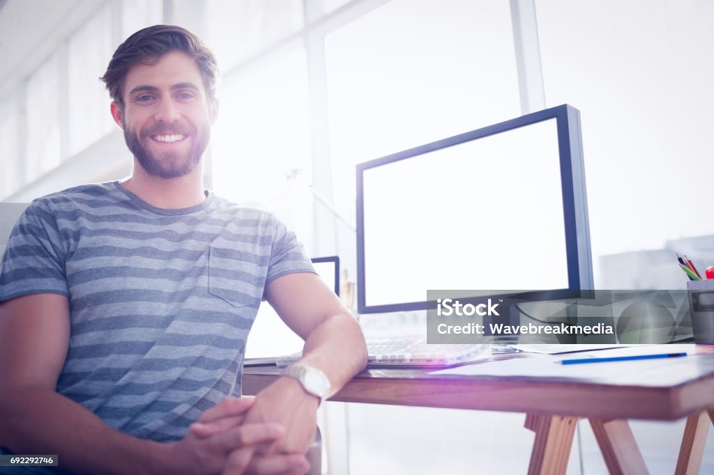 Casual businessman smiling at the camera Close up view of a casual businessman smiling at the camera Men Stock Photo