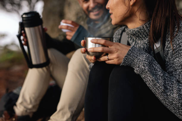 istock Couple hiking talking rest and drinking coffee 692292802