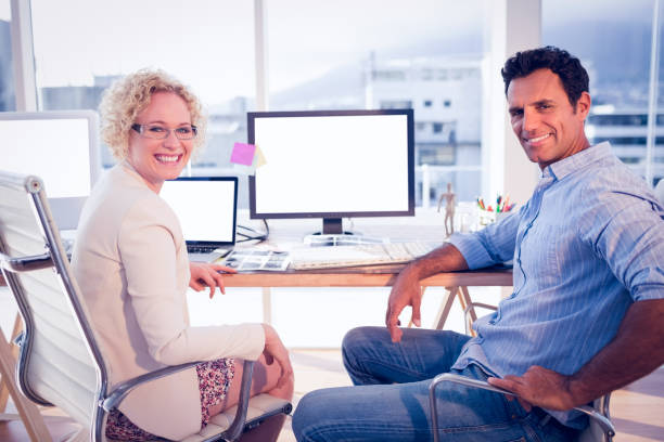 istock Happy business colleagues smiling at the camera 692293078