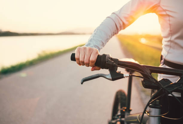 istock Close up woman hand on the bicycle handlebars 692315748