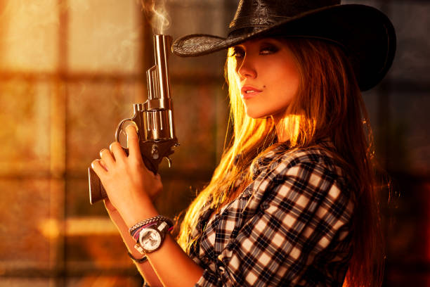 istock Young woman with gun 692321878