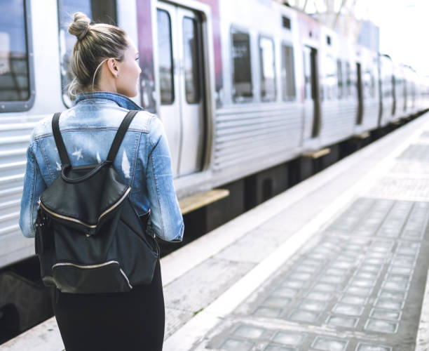 istock Woman traveler with backpack on rail station checking time 692325742