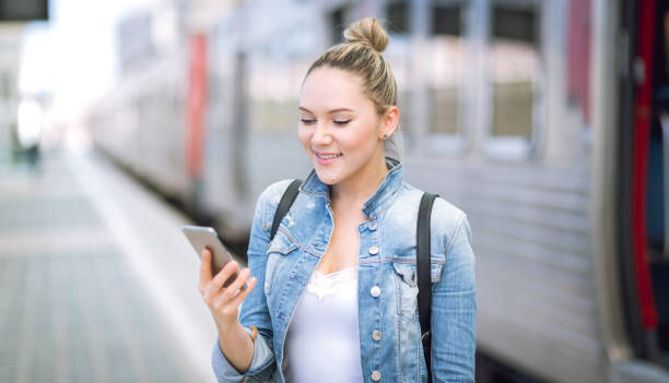 istock Woman traveler with backpack on rail station checking time 692325766