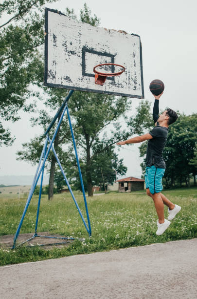 istock Street basketball player doing a slam dunk 692328744