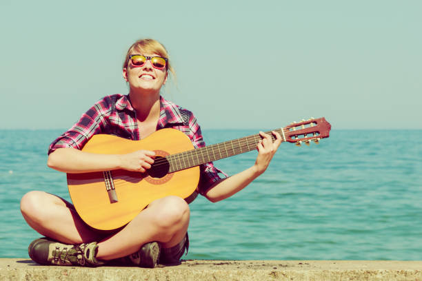 istock Young woman with guitar outdoor 692340530
