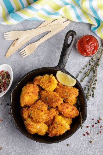 istock Fried nuggets of chicken breast with ketchup and spices. Selective focus 692343294