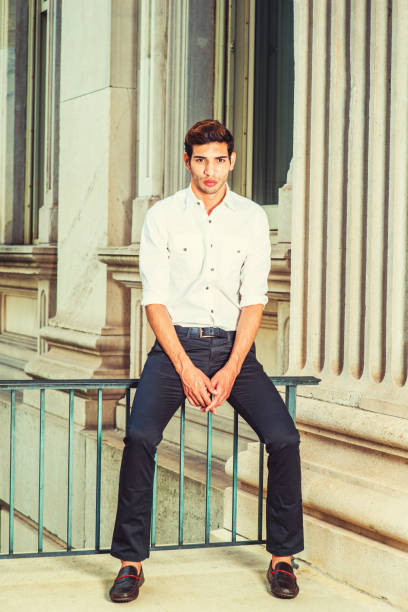 istock Young American Man sitting outside, thinking, relaxing. 692354174