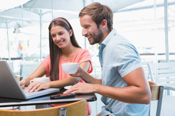istock Young happy couple looking at a laptop 692354196