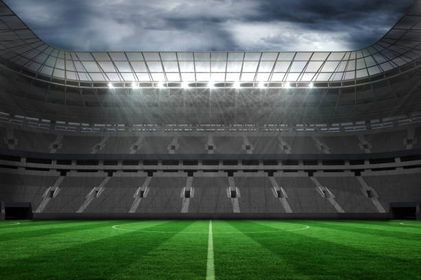 istock Large empty football stadium with lights 692354438