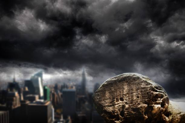 istock Large rock overlooking dark city 692354740