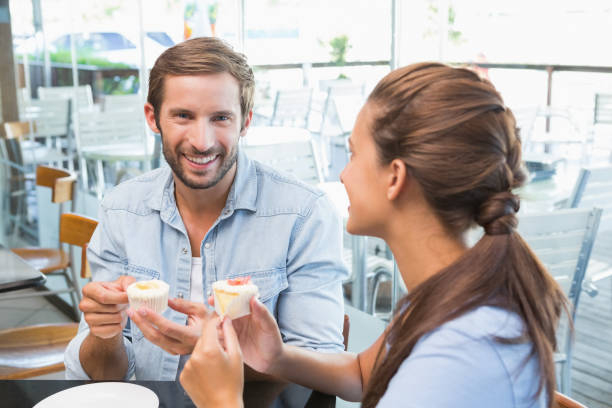 istock Young happy couple eating cake 692359992