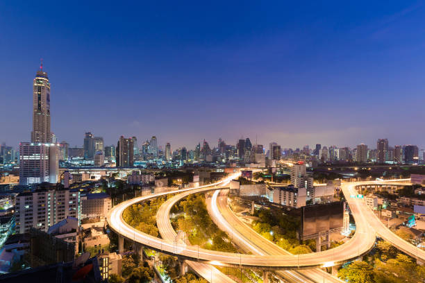 istock Twilight, aerial view highway interchanged and city downtown 692371366